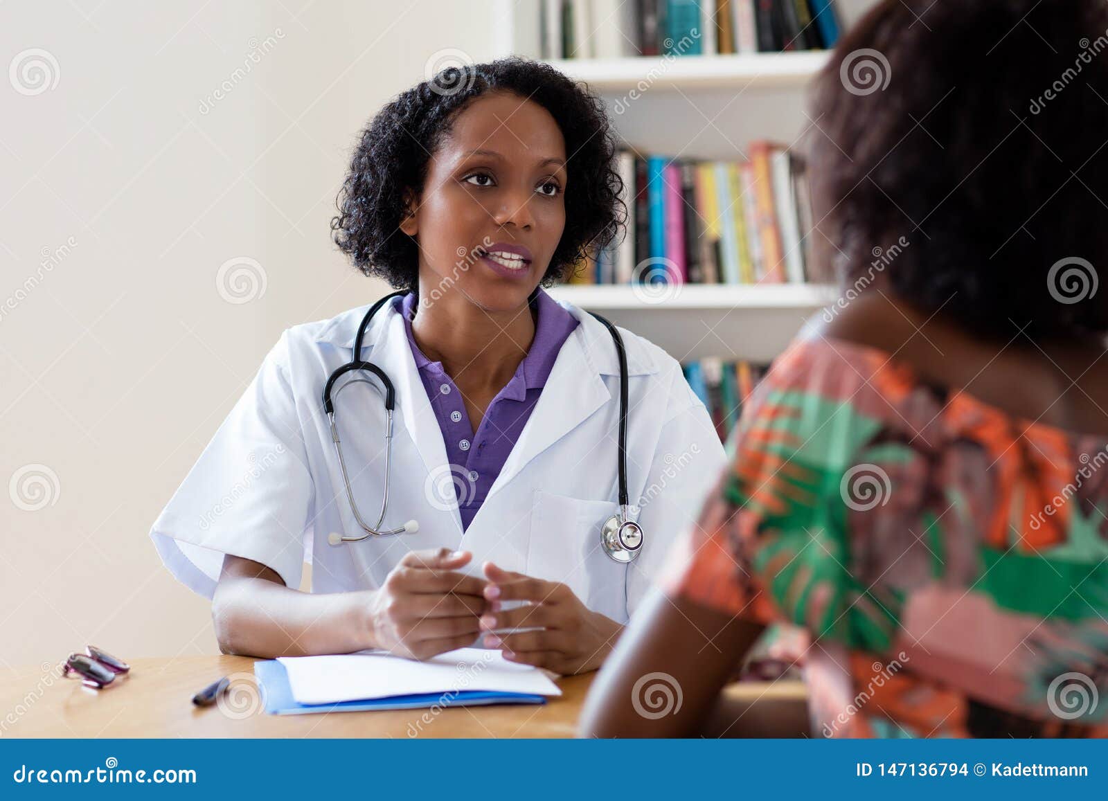 african american female doctor talking to patient