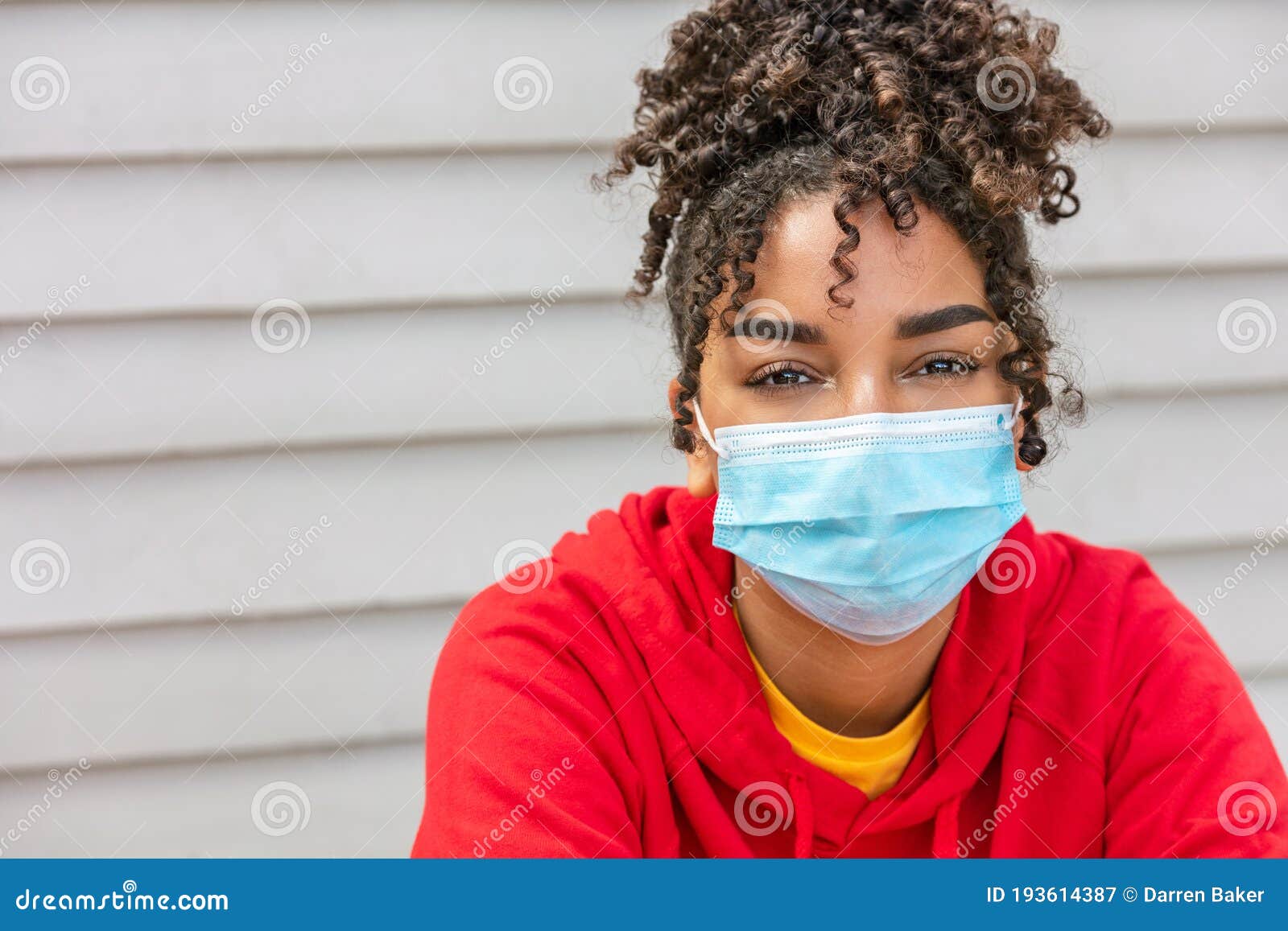 african american female young woman wearing face mask in coronavirus covid-19 pandemic