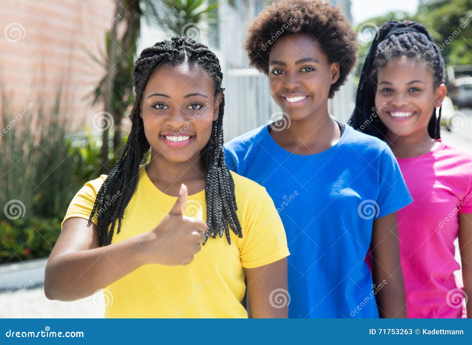 African American Girl with Two Girlfriends Showing Thumb Stoc image pic