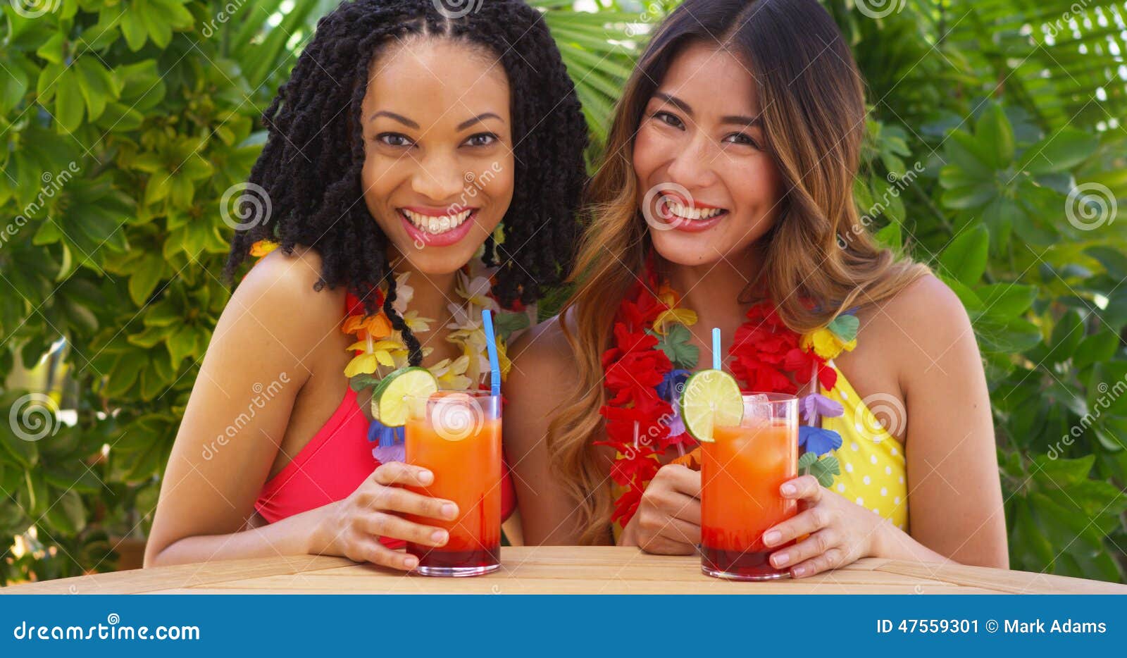African American and Japanese Best Friends Enjoying Tropical Vacation Together Stock Image pic