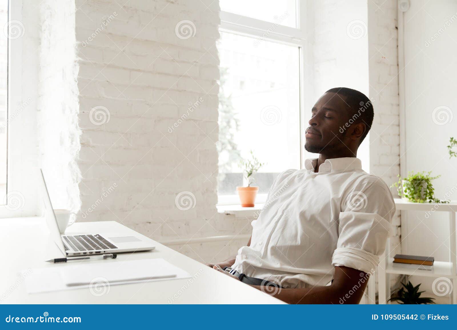 african-american man relaxing after work breathing air in home o