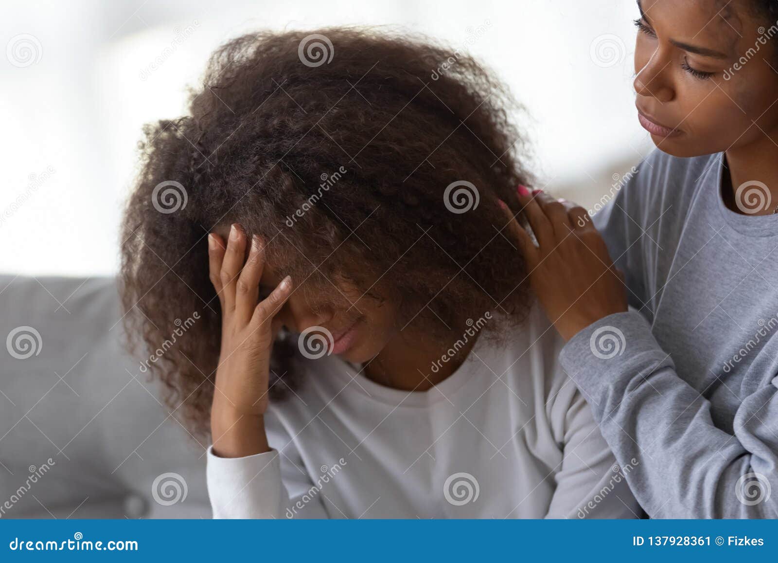 african american mom hug comforting sad teenage daughter