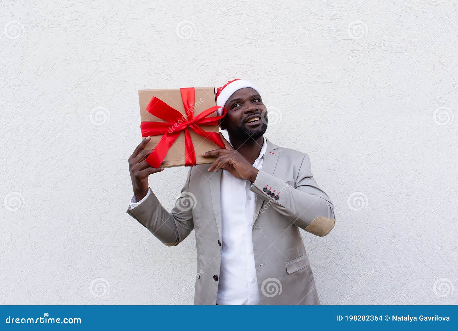 African American in New Year`s Cap with a Gift Stock Photo - Image of ...