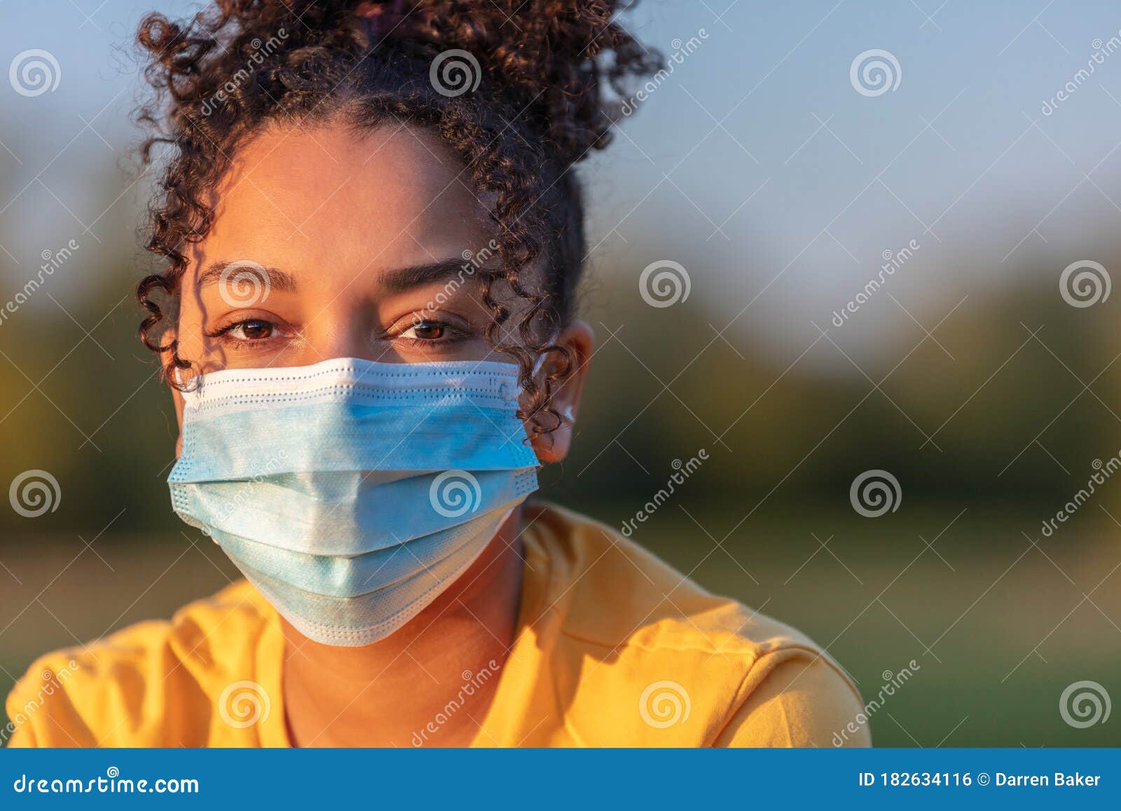 african american teenager girl woman wearing coronavirus covid-19 face mask