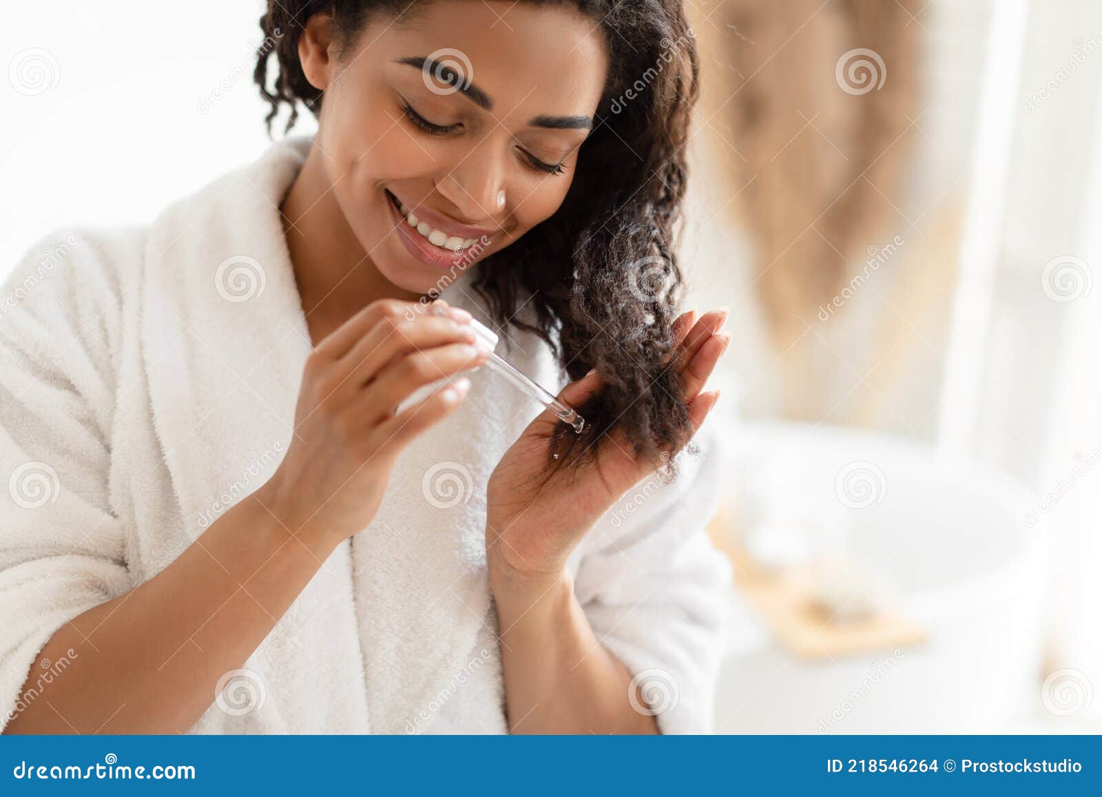 African American Woman Applying Serum on Damaged Hair in Bathroom Stock  Photo - Image of bathrobe, haircare: 218546264