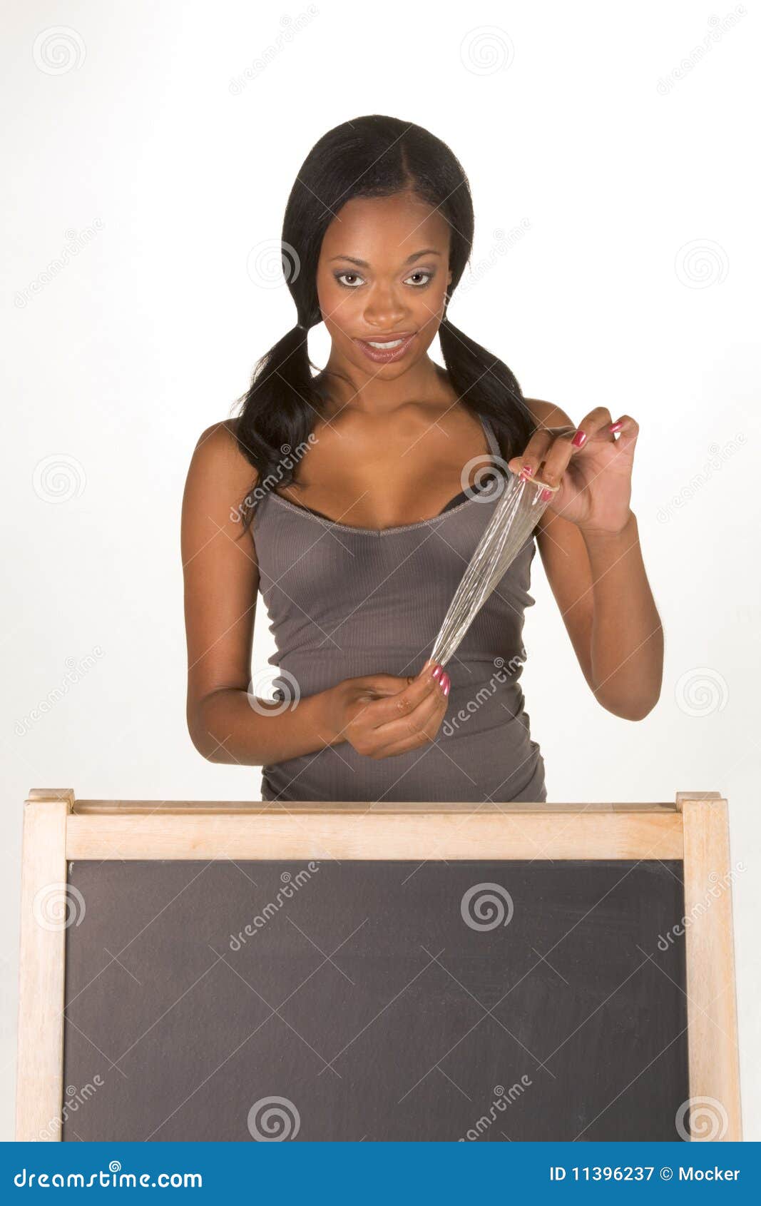 African American Woman With Condom By Blackboard Stock