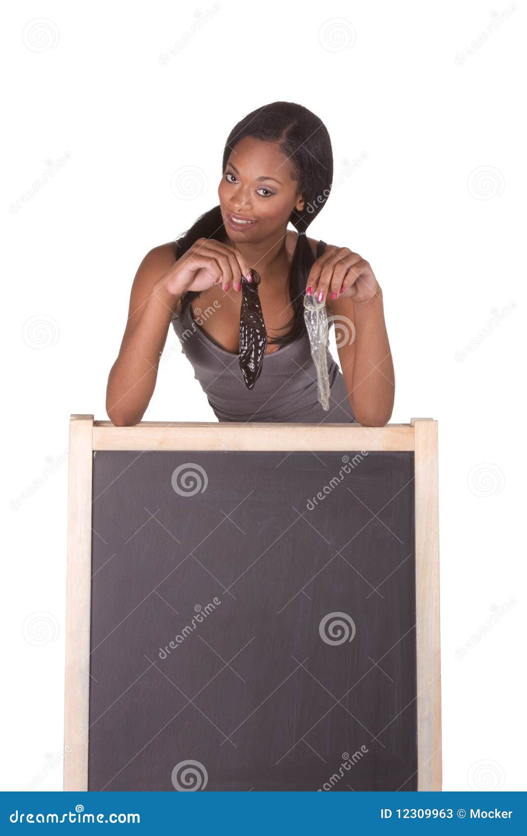 African American Woman With Condoms By Blackboard Stock