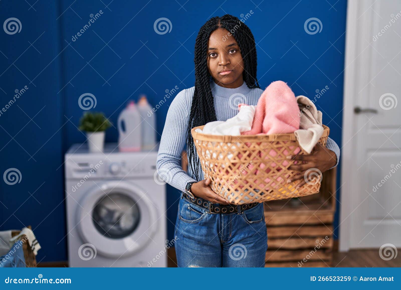 African American Woman Holding Laundry Basket Thinking Attitude and ...