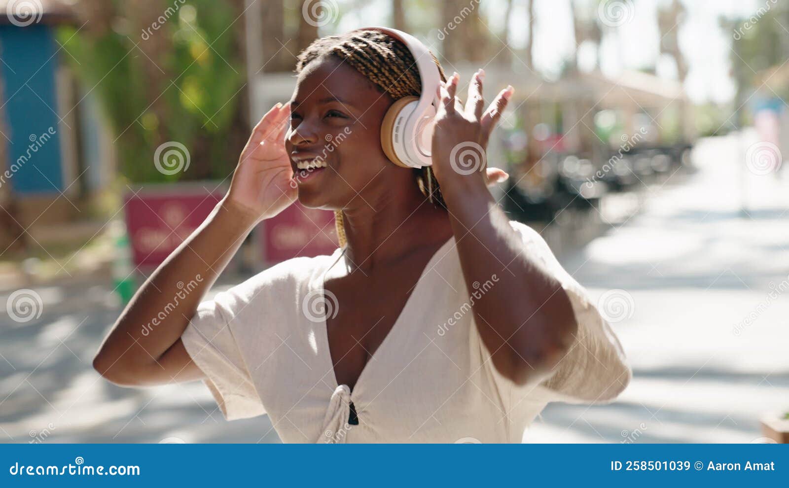 African American Woman Listening To Music and Dancing at Street Stock
