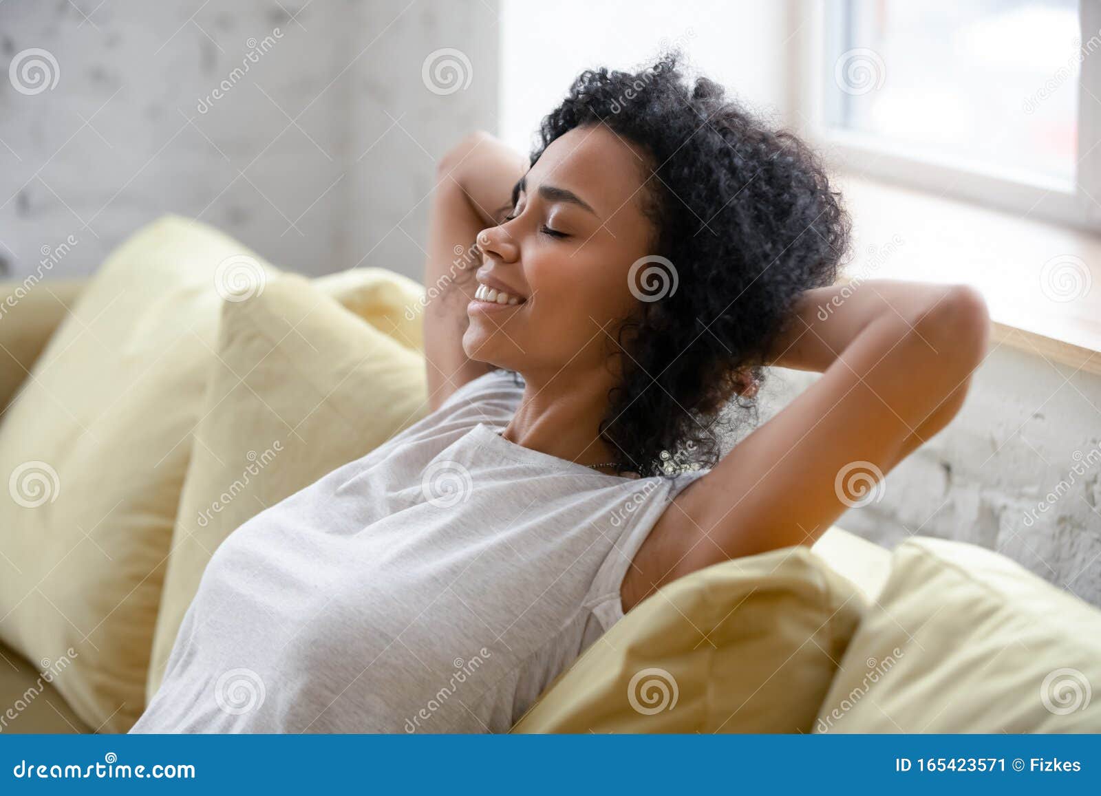 african american woman relax on comfortable couch at home