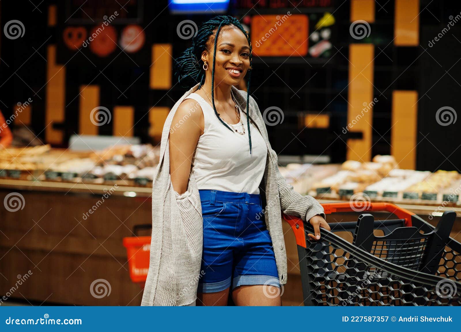 African American Woman with Shopping Cart Trolley in the Supermarket ...