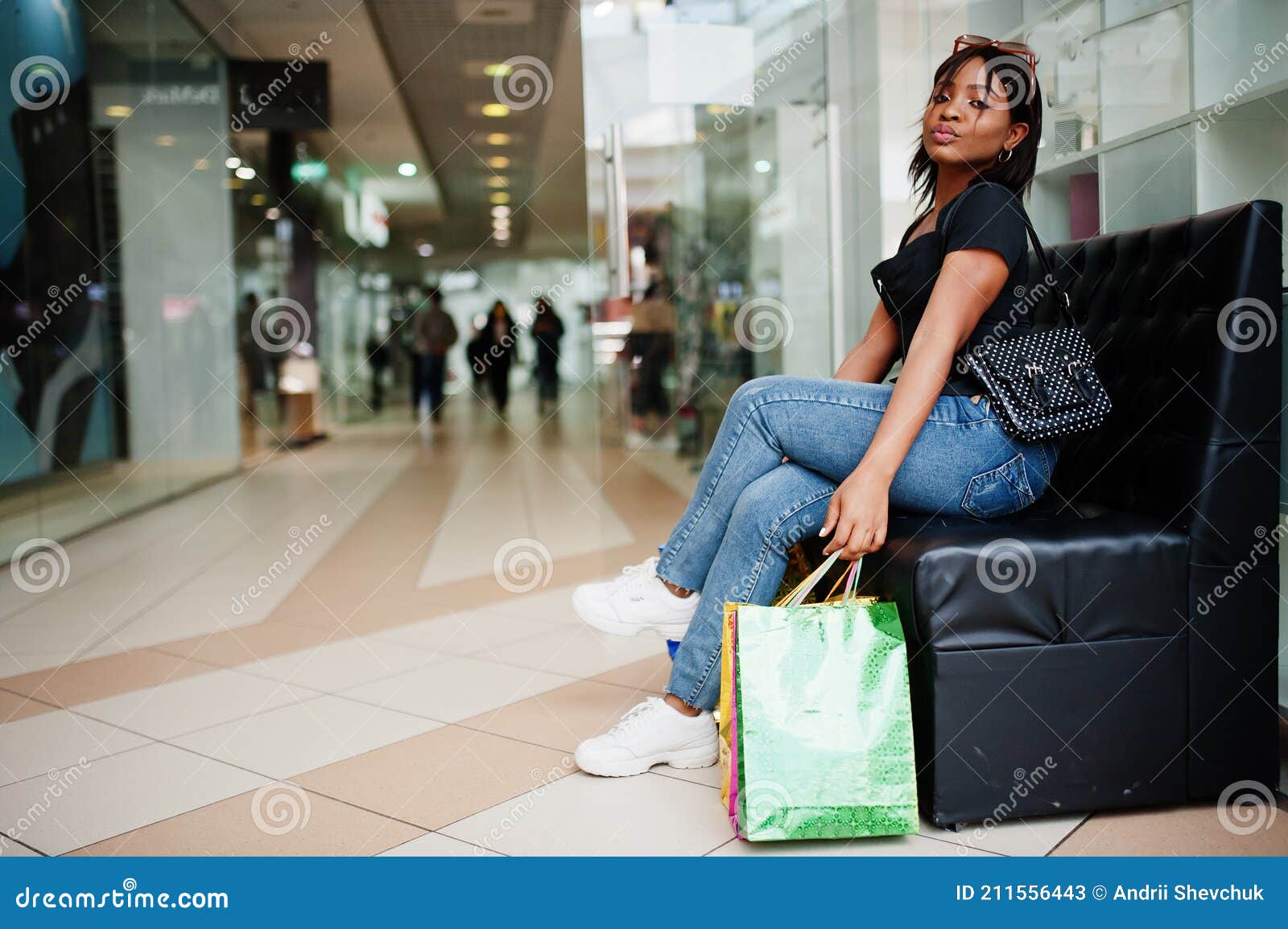 African-american Woman with Coloured Shopping Bags in Mall Shopping ...