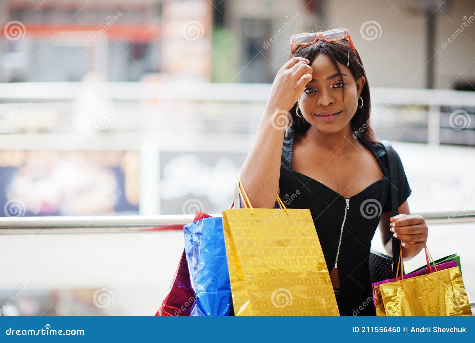 African-american Woman with Coloured Shopping Bags in Mall Shopping ...