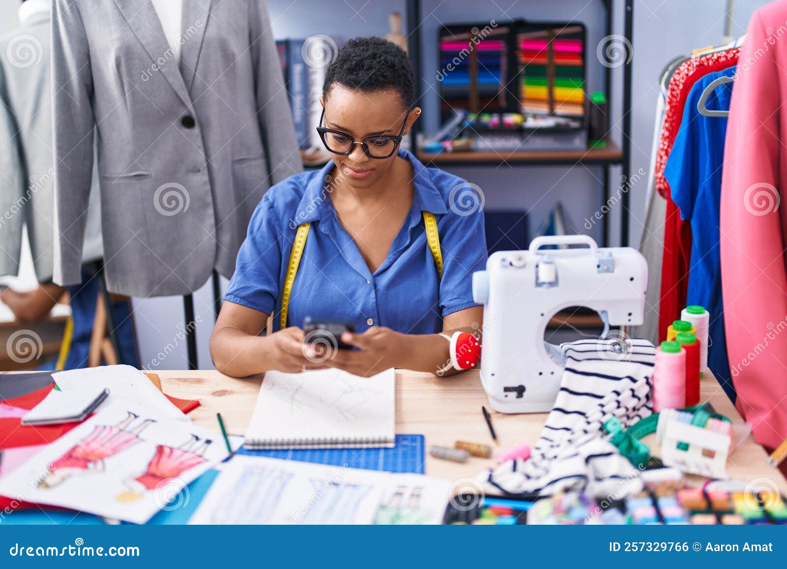 African American Woman Tailor Smiling Confident Using Smartphone at ...