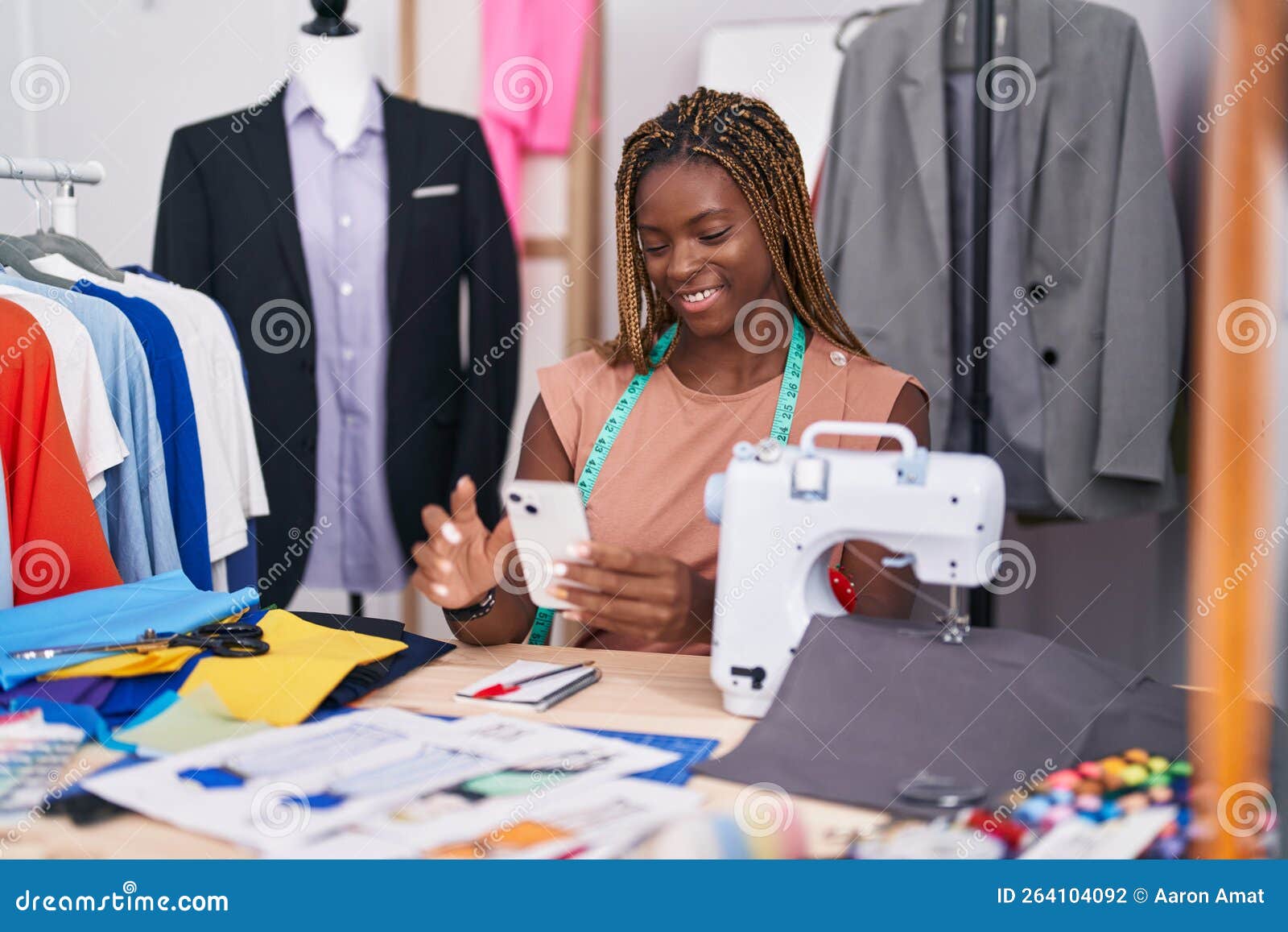 African American Woman Tailor Smiling Confident Using Smartphone at ...