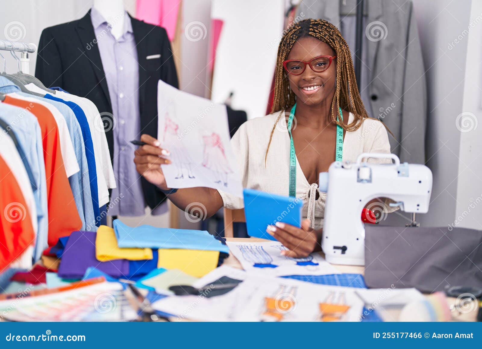 African American Woman Tailor Using Touchpad Looking Clothing Design at ...