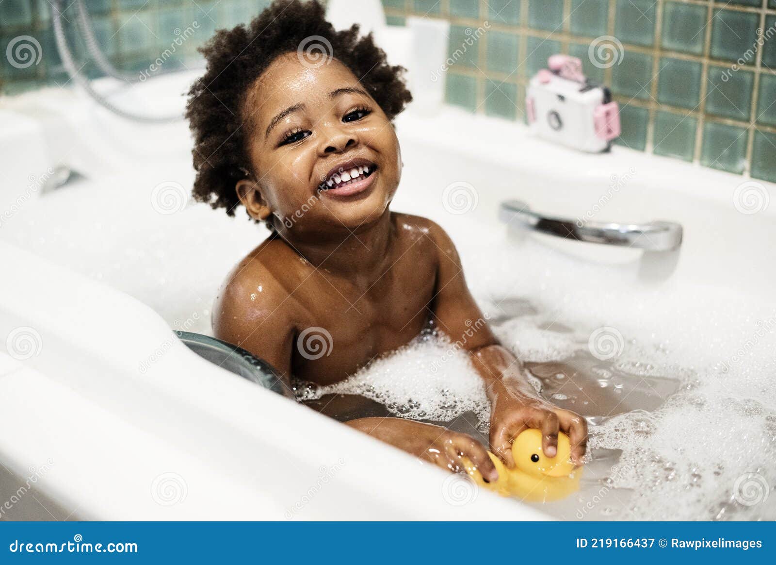 african descent kid enjoying bath tub