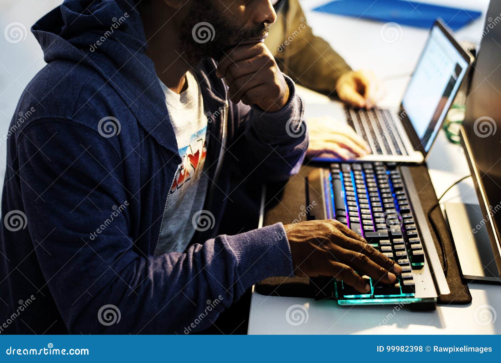 African Descent Man Hands Working on Computer Keyboard Stock Photo