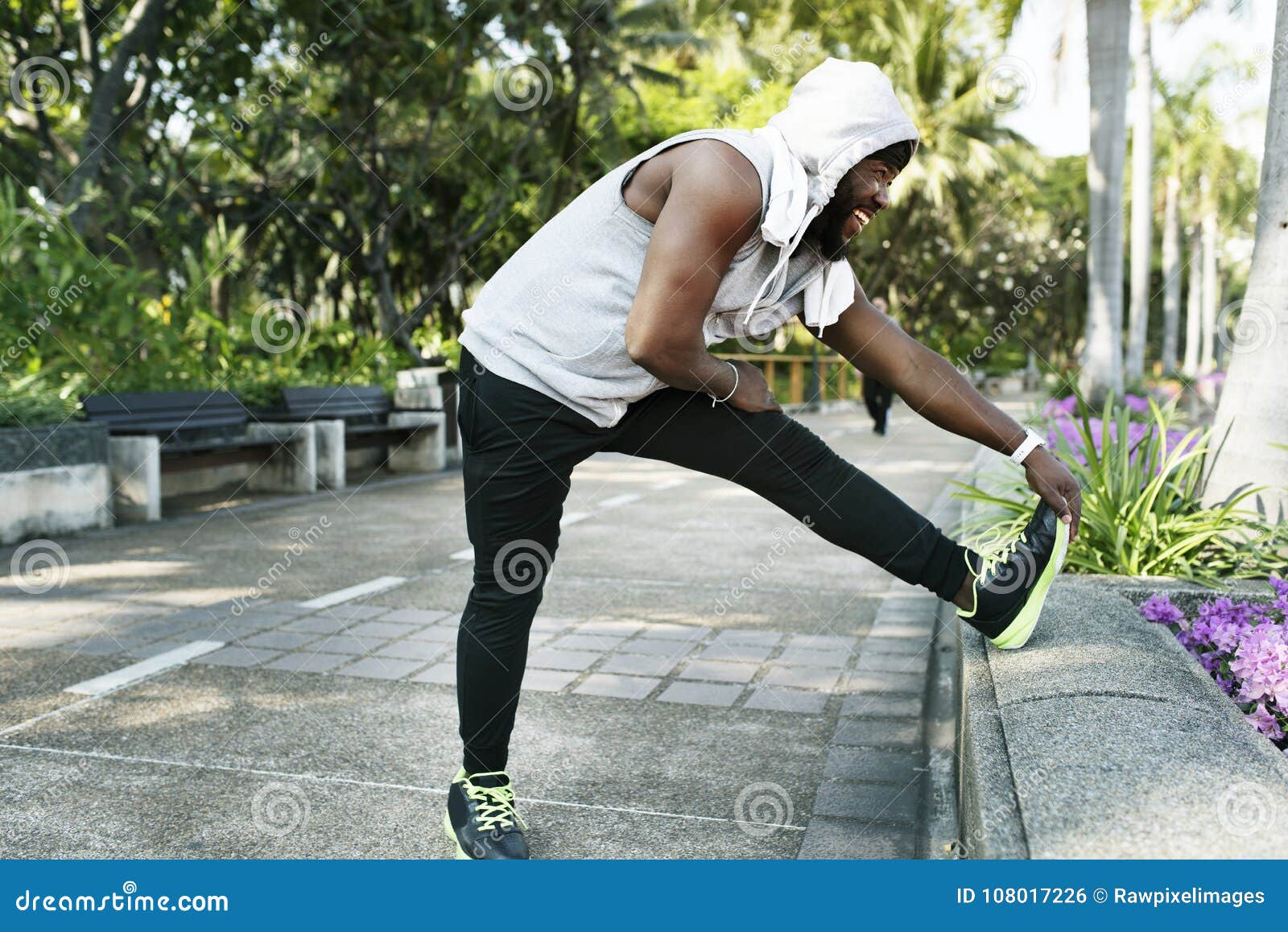 african descent man stretching at the park