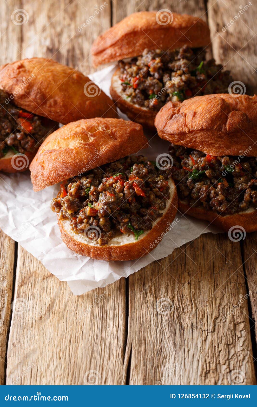 african dish vetkoek: fried yeast dough sandwich with meat curry