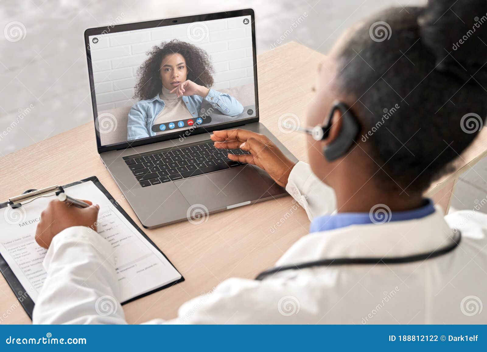 african doctor talk to patient by online webcam video call on laptop screen.