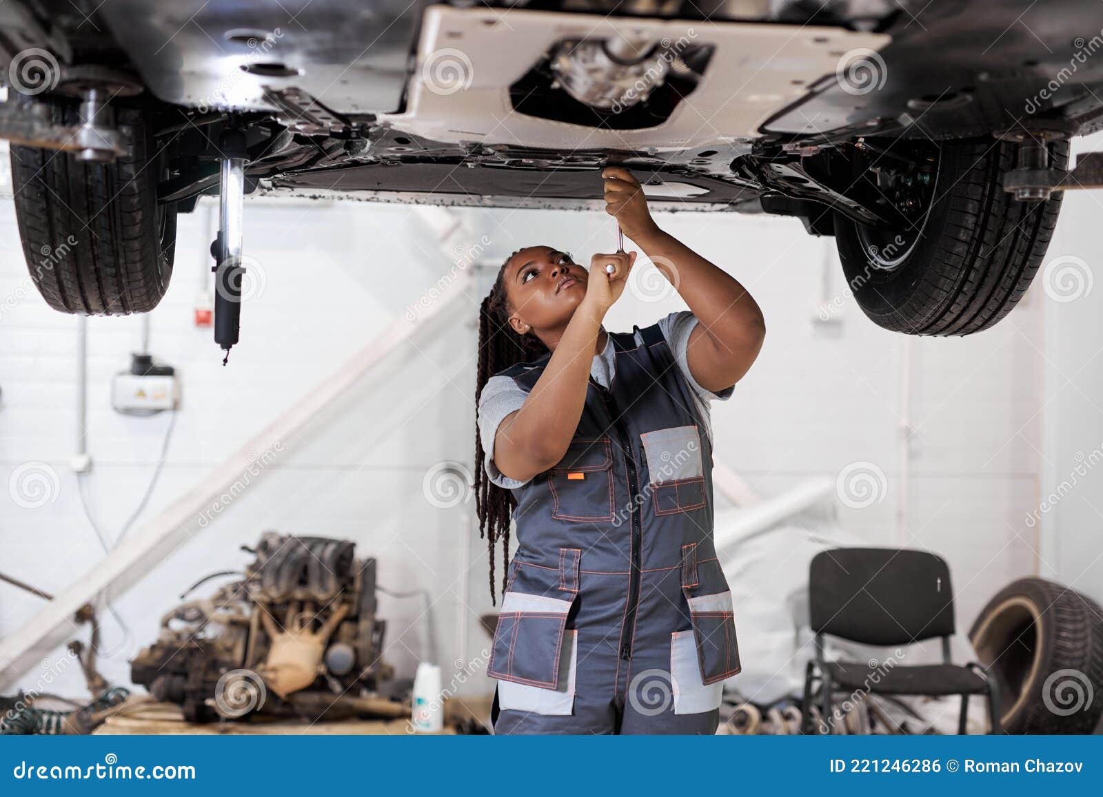 African Female Auto Mechanic Fixing Car, Mechanic Repairing Car On Lift ...