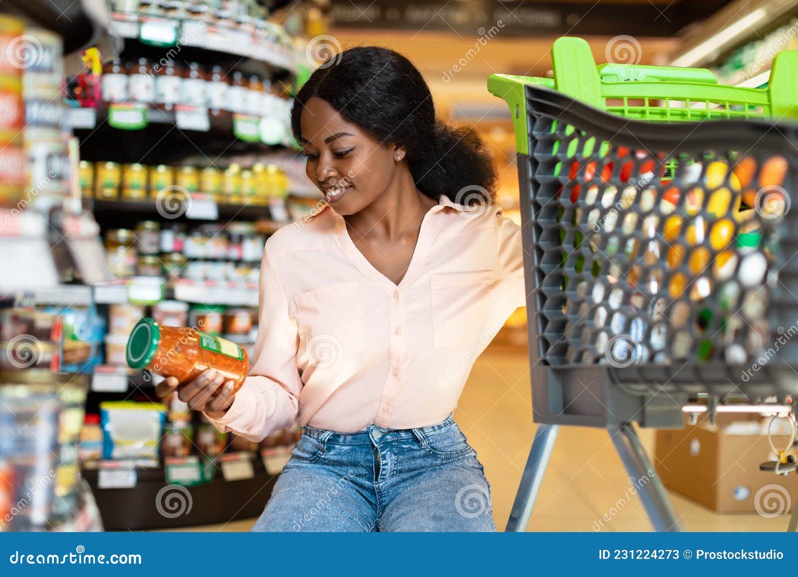 African Female Buying Groceries Holding Jar Shopping in Supermarket ...