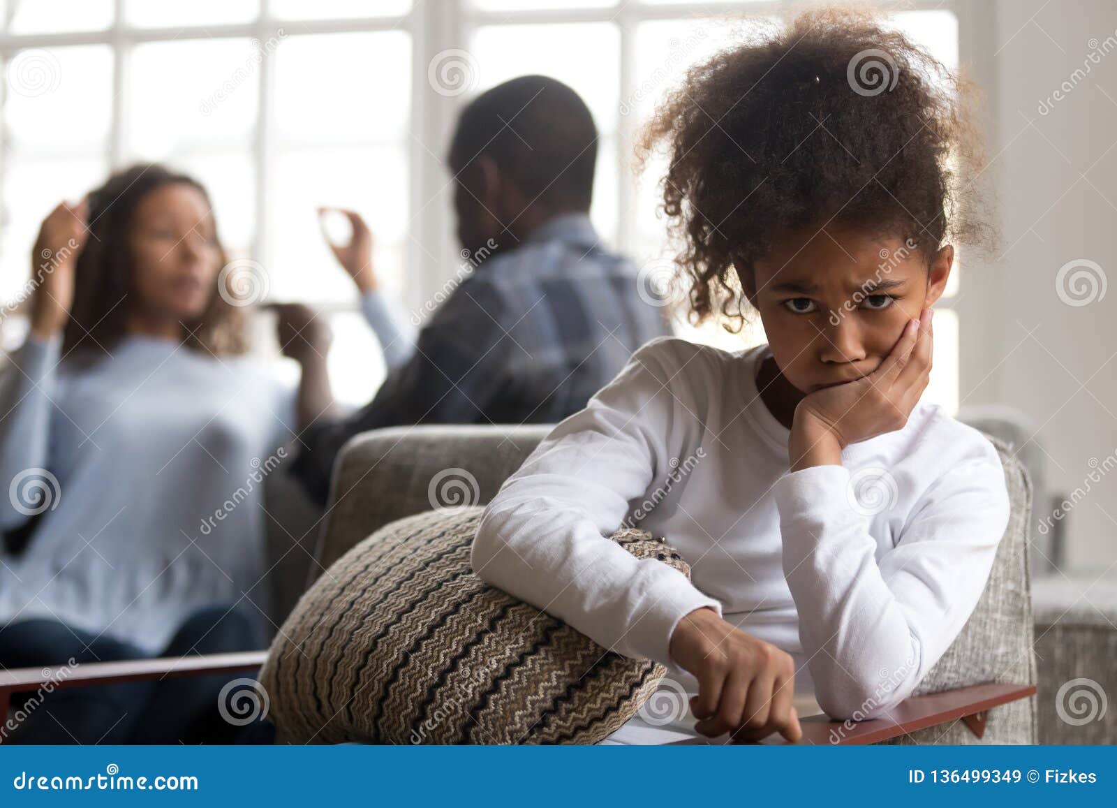 african kid daughter upset of parents fighting looking at camera