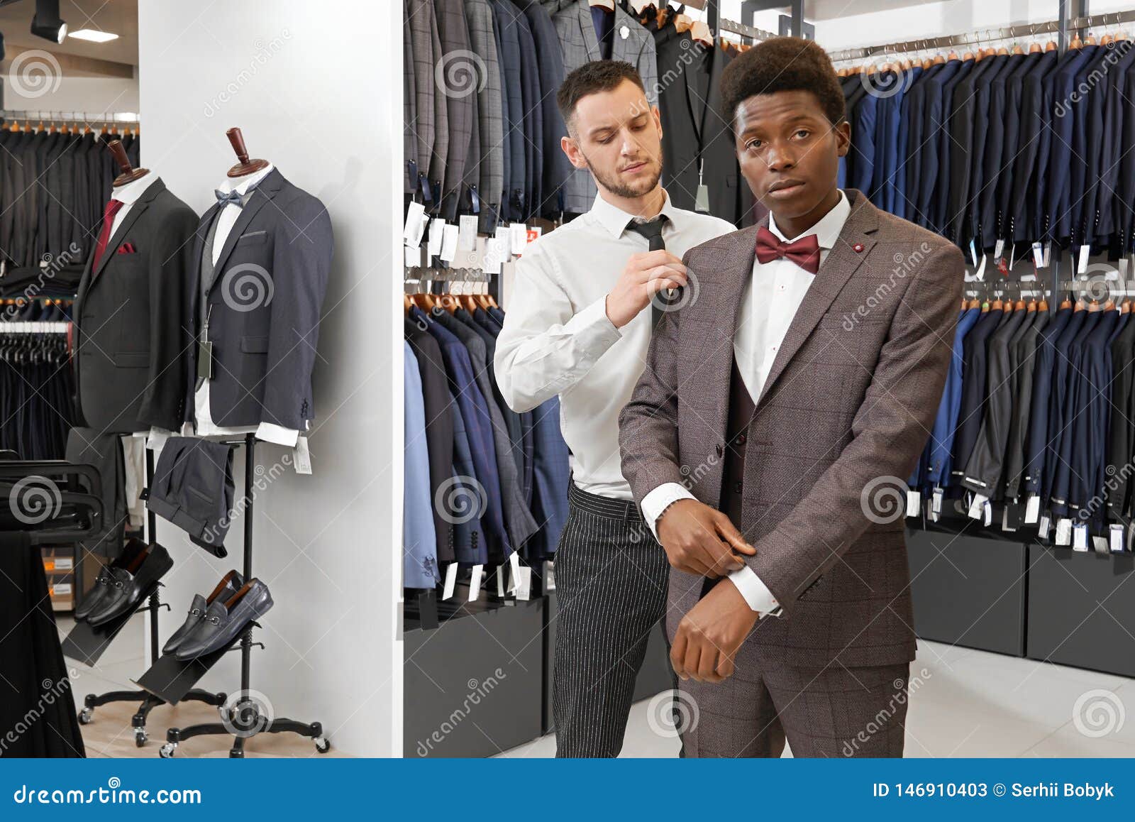 African Man in Boutique Trying on, Choosing Elegant Suit. Stock Image ...