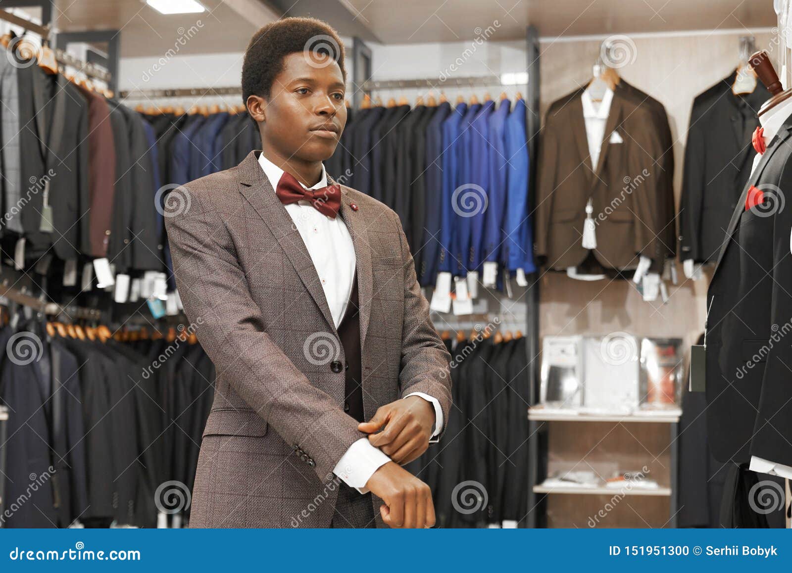 African Man Choosing Elegant Suit in Fashionable Boutique. Stock Photo ...