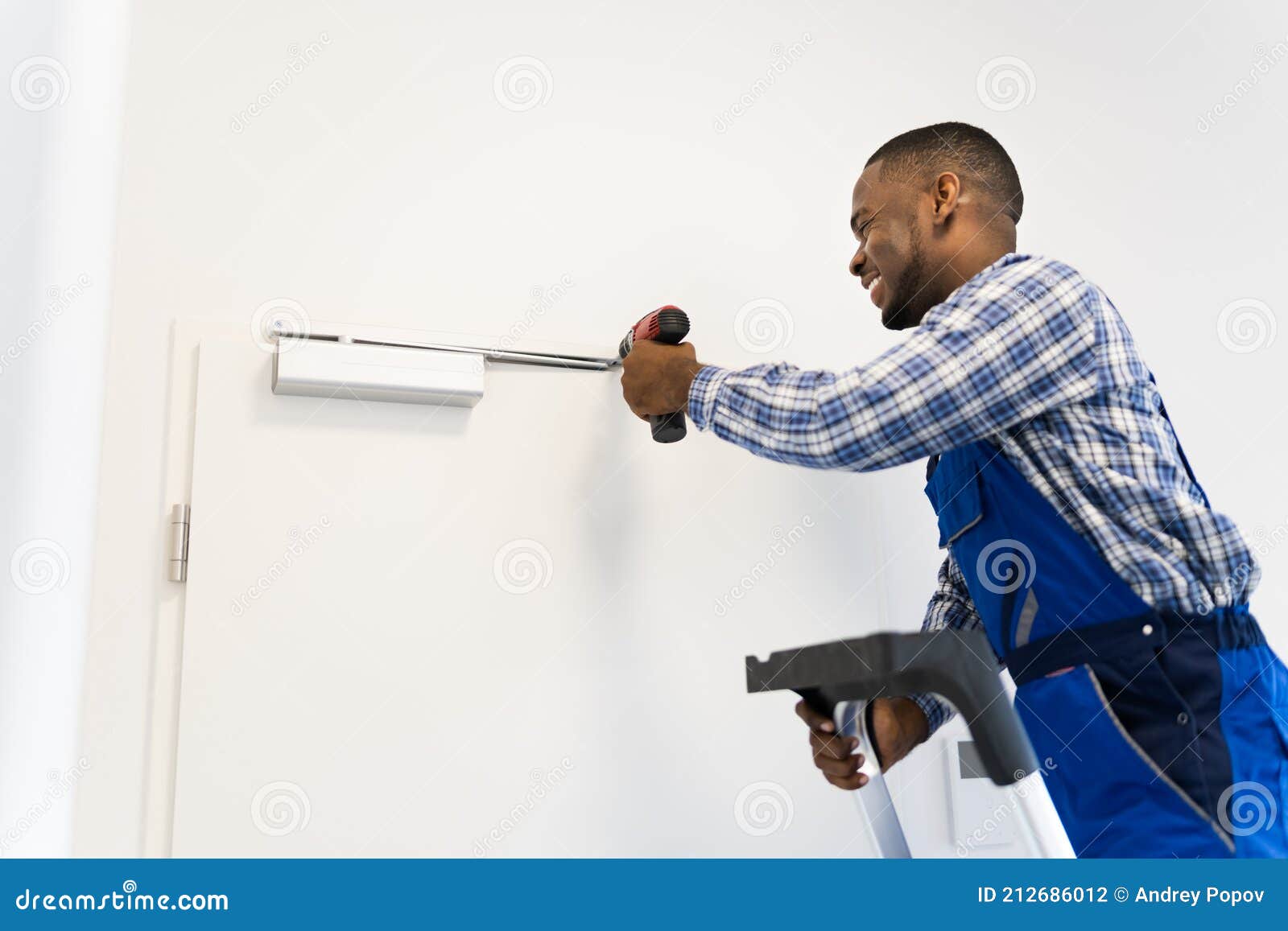 African Man Installing and Fixing Door Closer Stock Photo Image of
