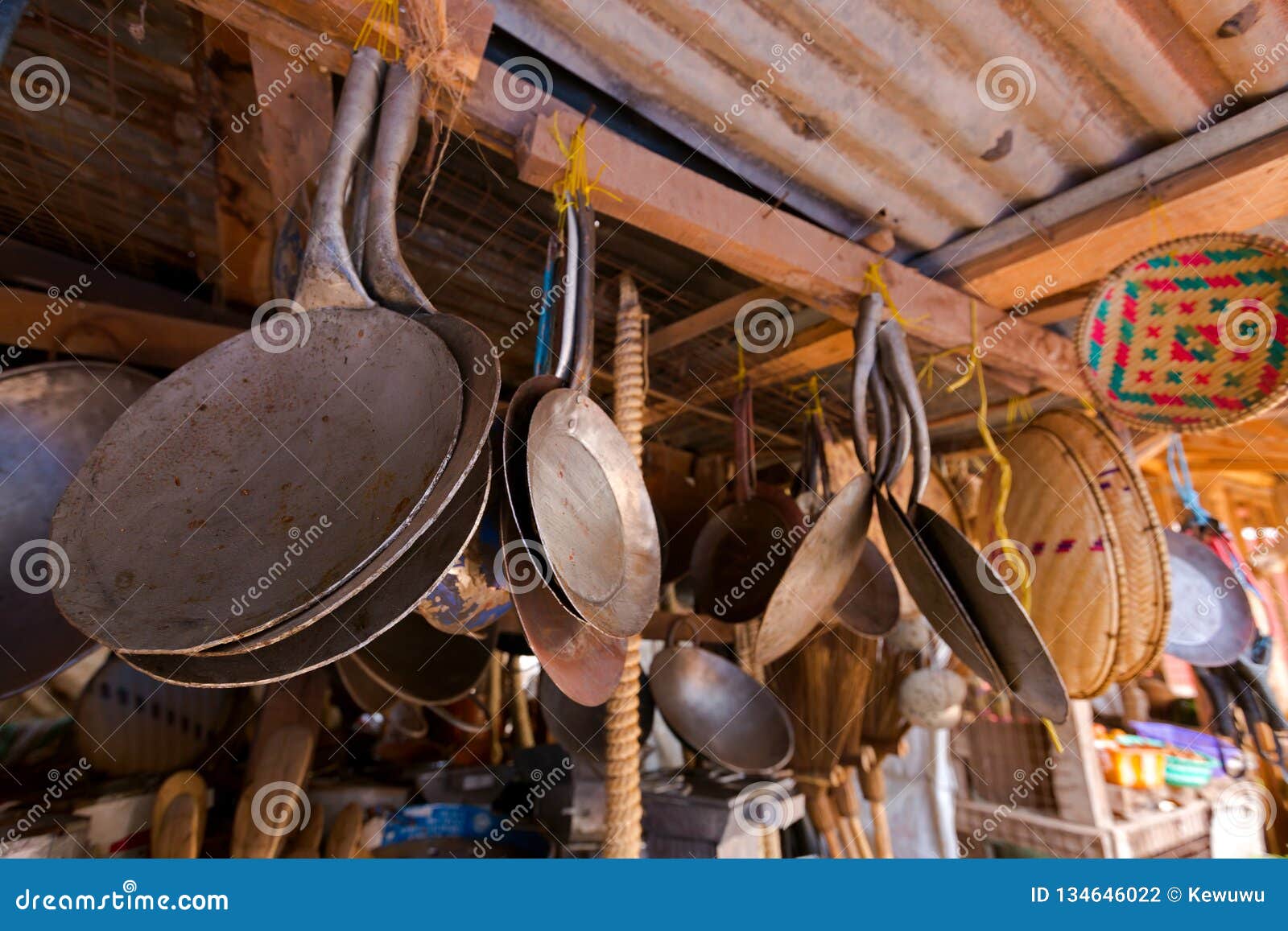 african mitad, flat cooking pan to make flatbread and other cooking utensils at fresh market in mto wa mbu village, tanzania