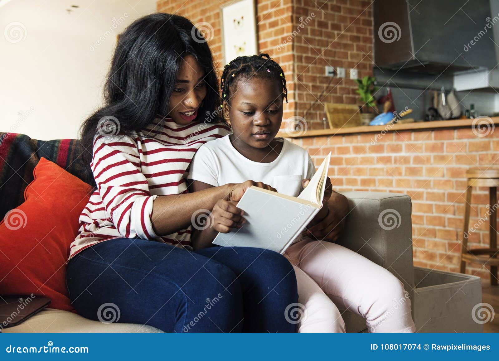 african mother helping her daughter in doing her homework