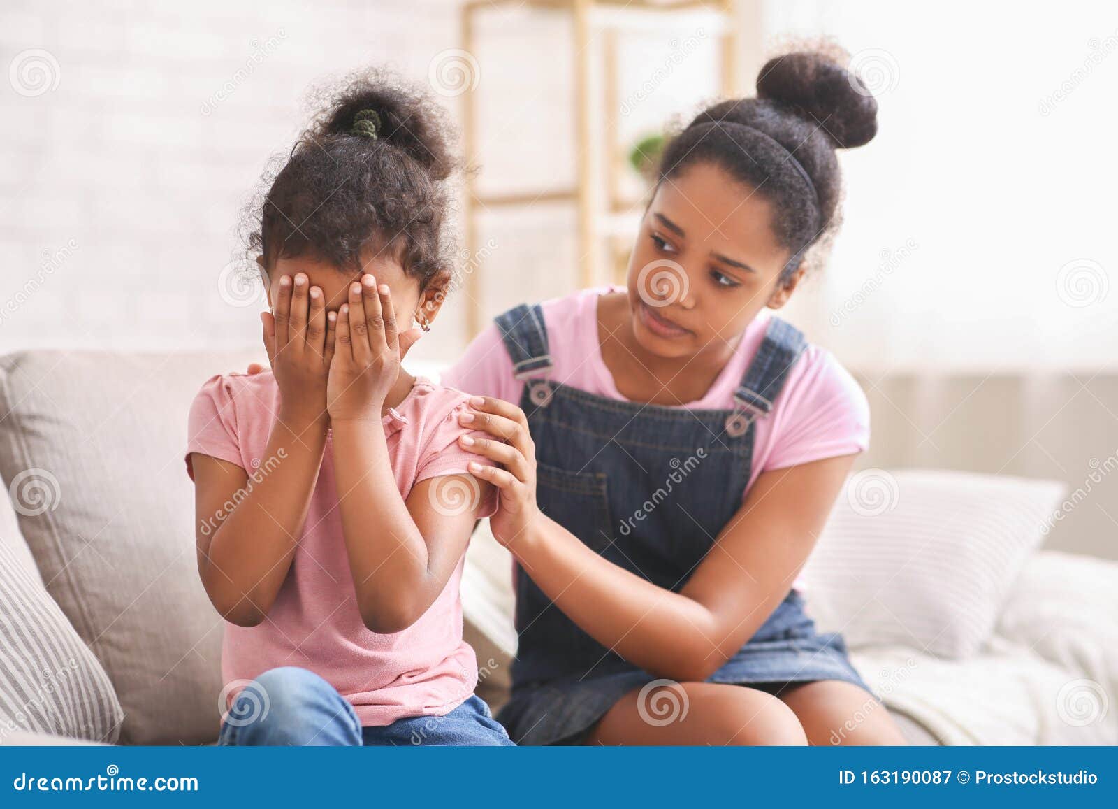African Teen Girl Embracing Her Crying Baby Sister Stock Image Image
