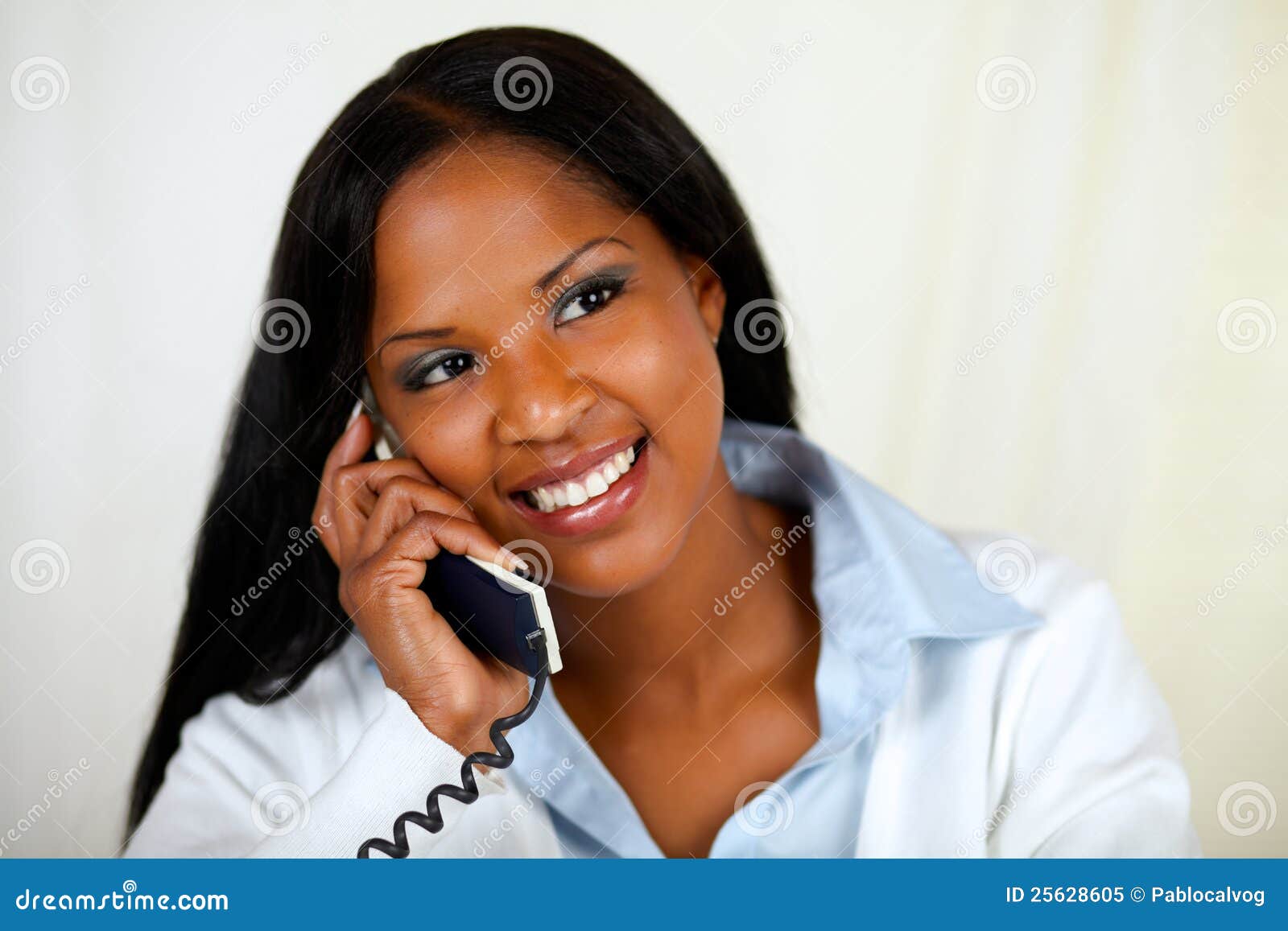 african woman conversing on phone