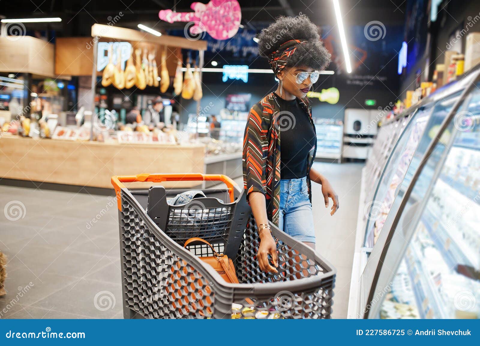 African Woman with Shopping Cart Choose Yogurt Bottle from Fridge at ...