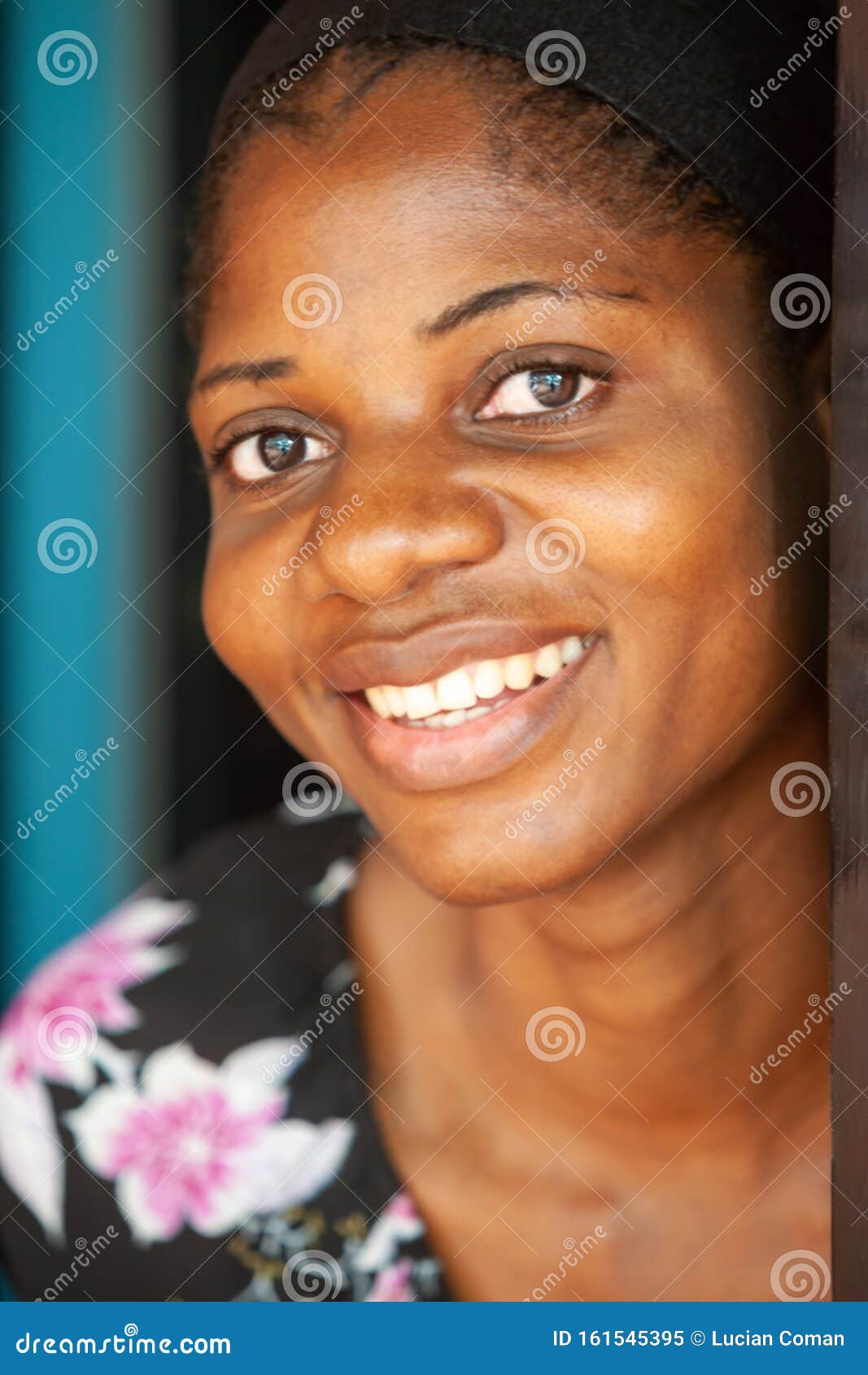 Portait Of African American Girl In Black Clothes Smiling At Camera