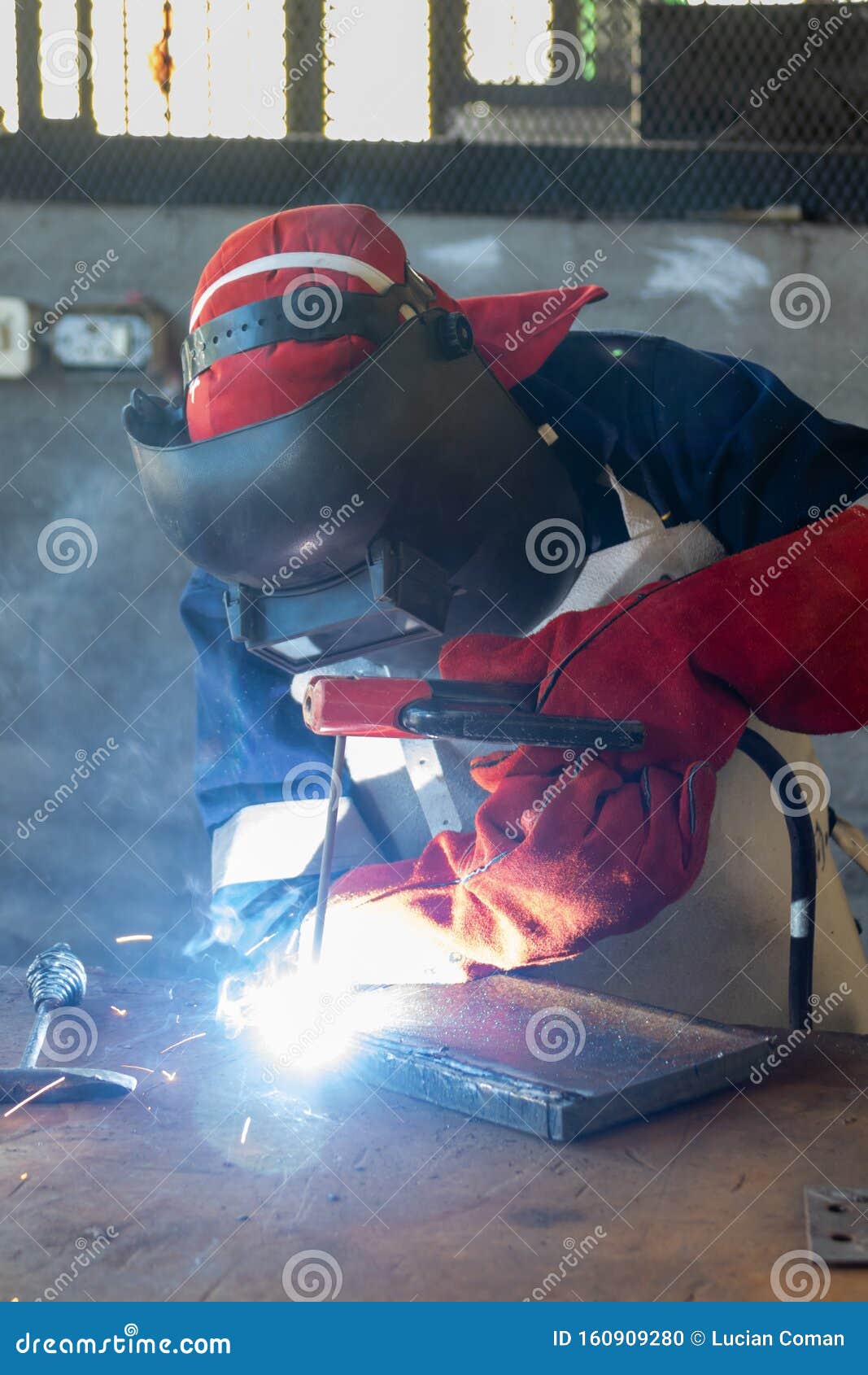 african worker welder with red gloves