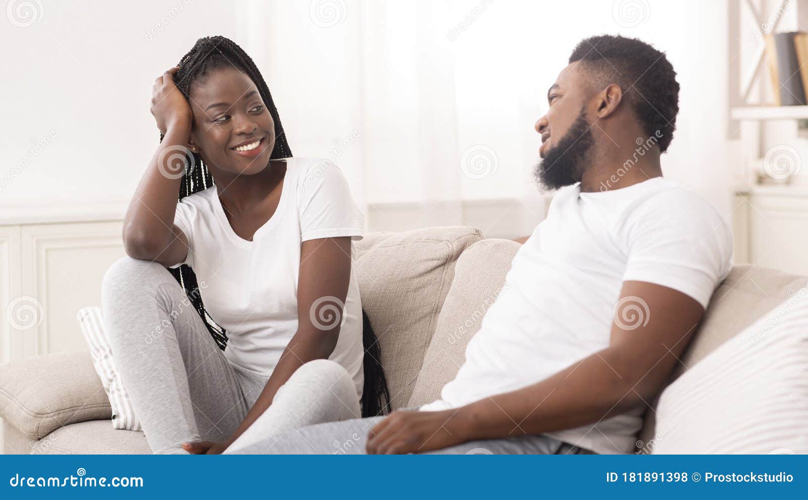 Afro Husband and Wife Chatting Together in Living Room at Hom pic