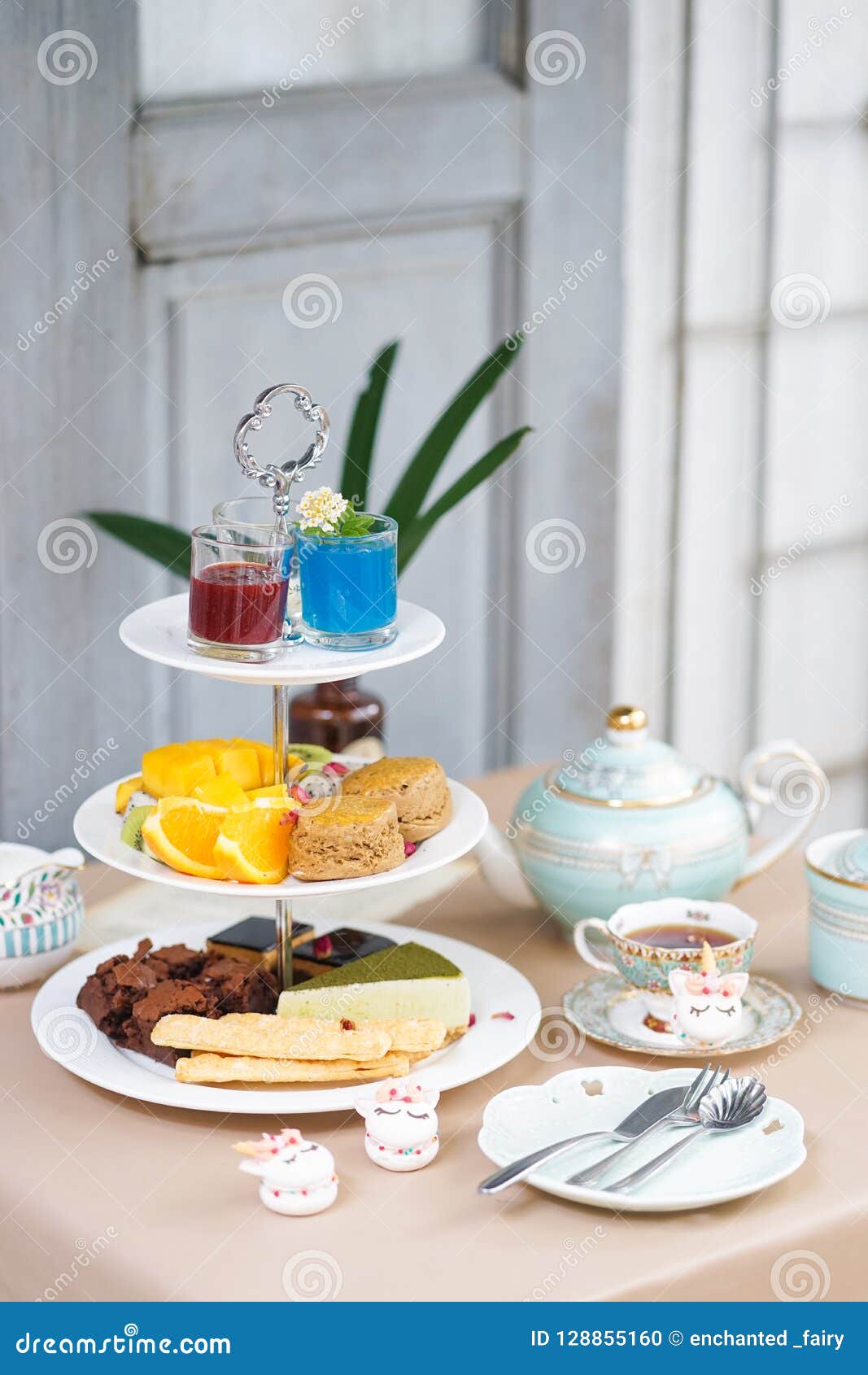 afternoon tea. tea party with unicorn macarons, scones, bakeries