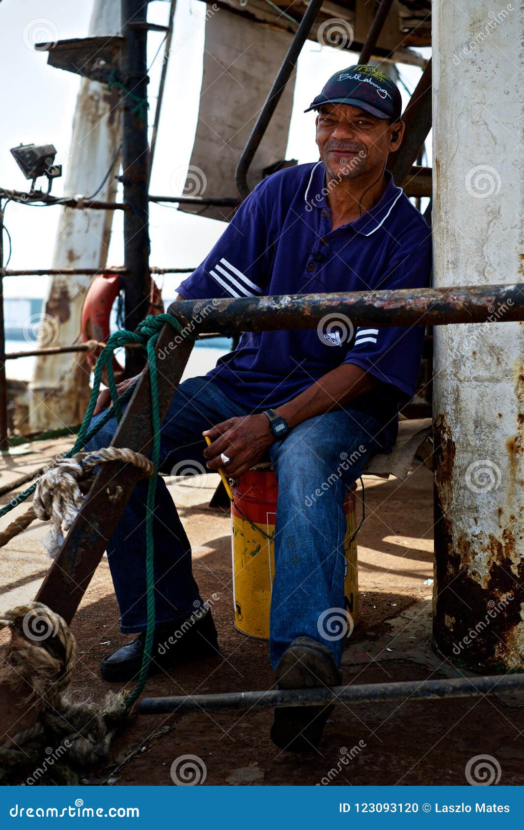 Security Guard Watching Over a Fishing Boat in the Dock Editorial Image