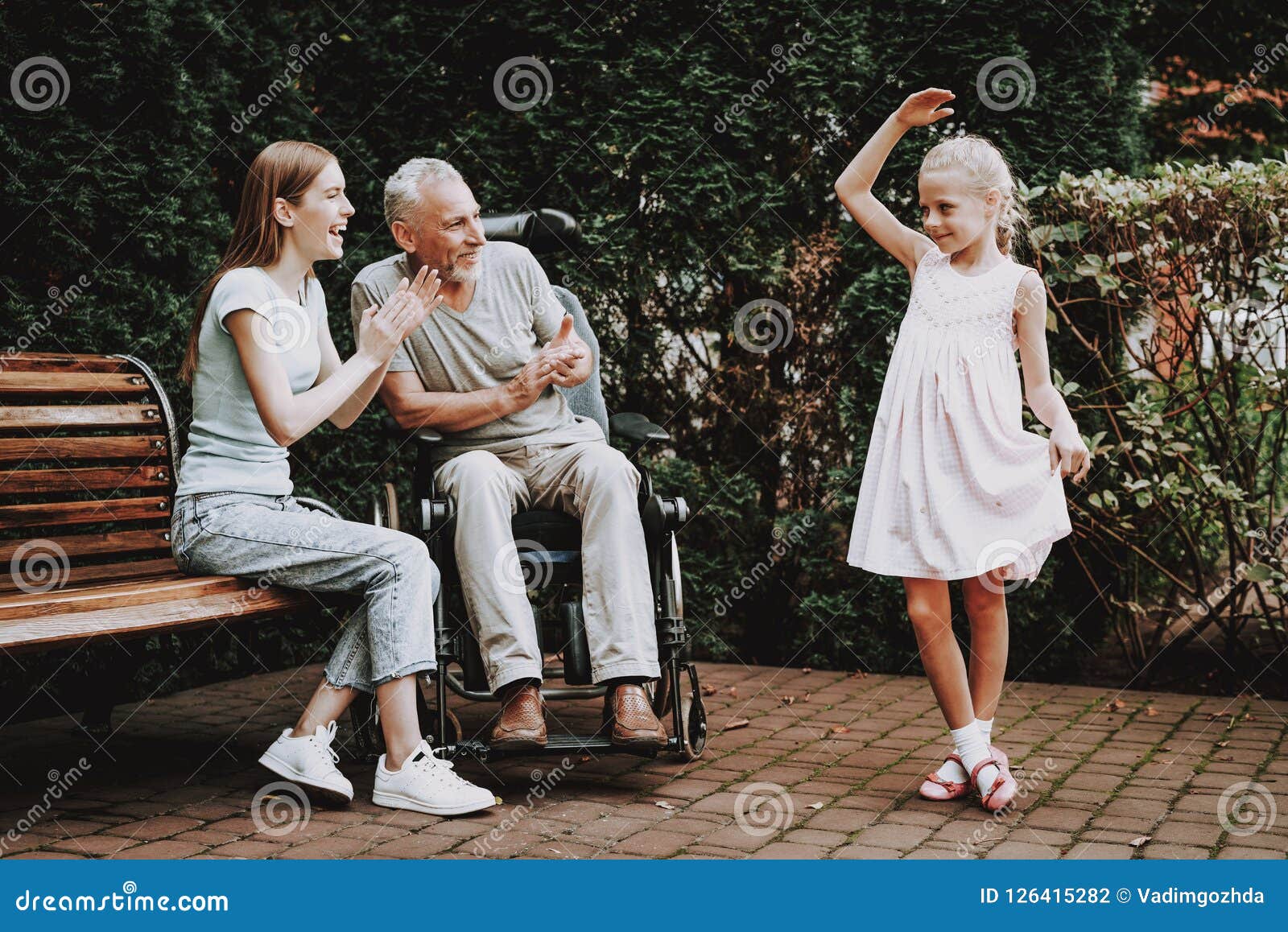 Aged And Young Family In Bench And Wheelchair Stock Photo Ima