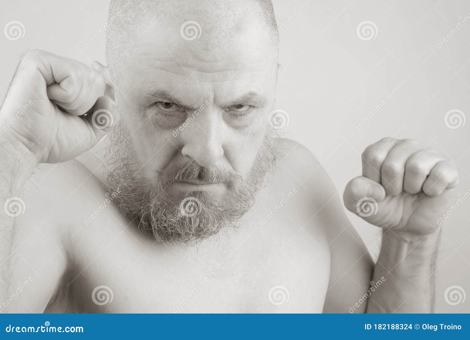 Aggressive Bearded Man With Clenched Fists In Black And White Photo