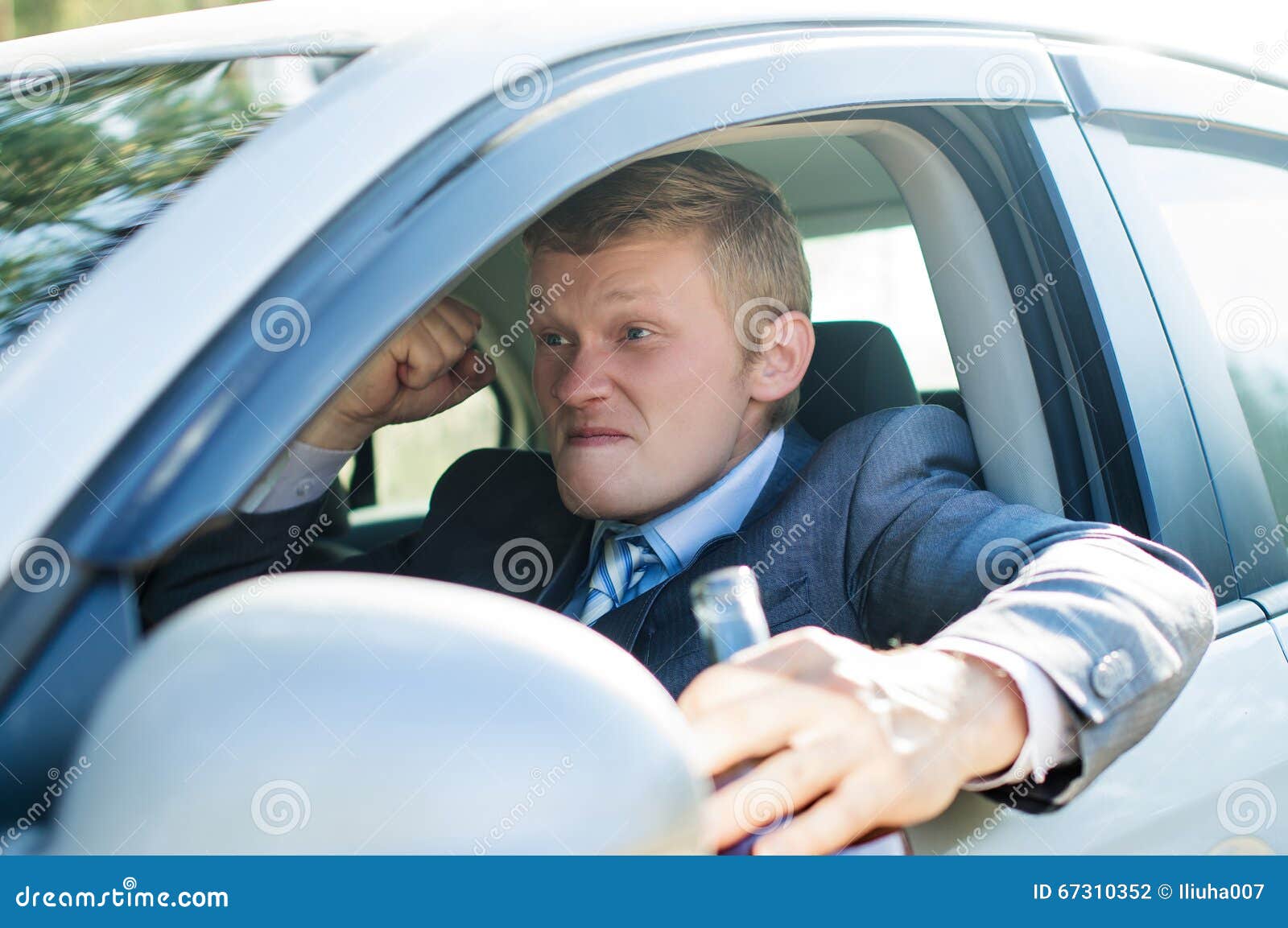 Aggressive Drunk Driver Behind the Wheel of of the Car Stock Photo
