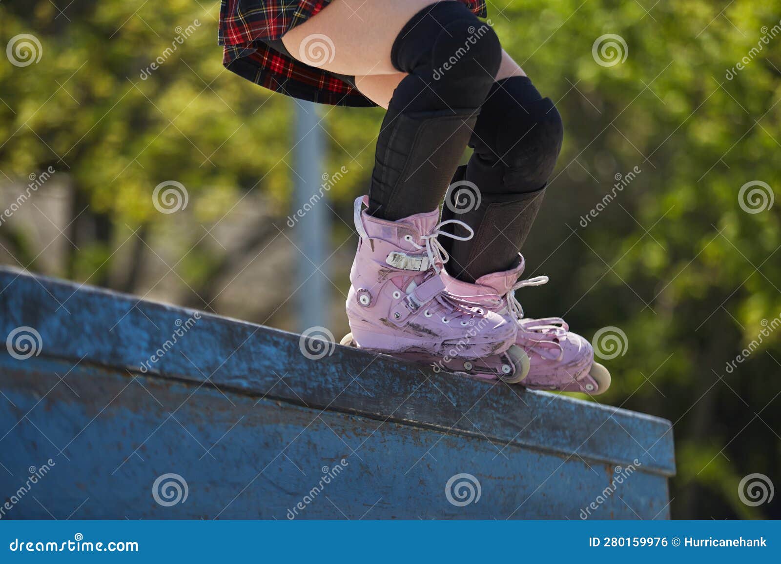 Skater Girl Grinding on a Ledge in a Outdoor Skatepark in Summer