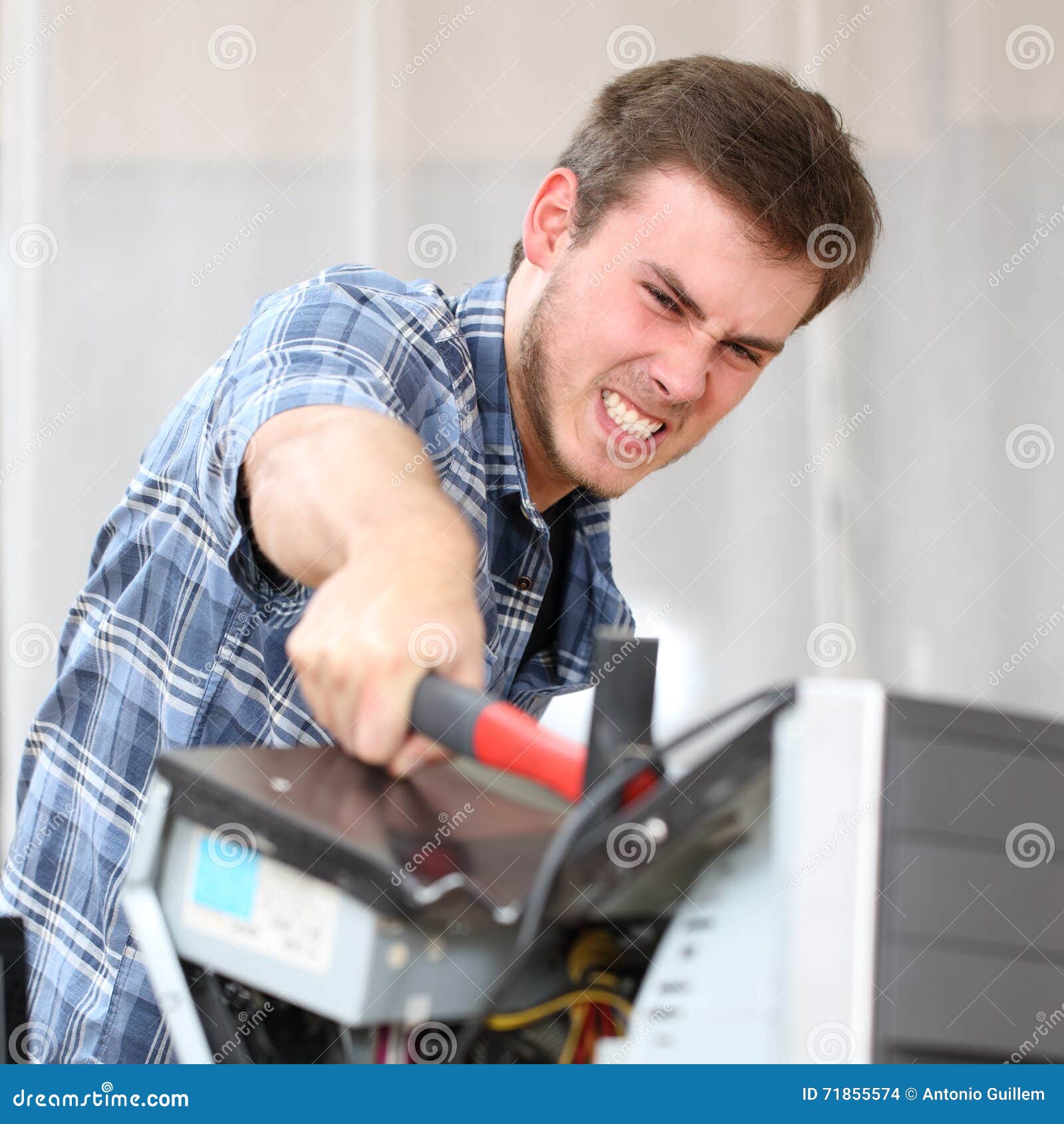 Aggressive Man Hitting a Computer with a Hammer Stock Photo Image of