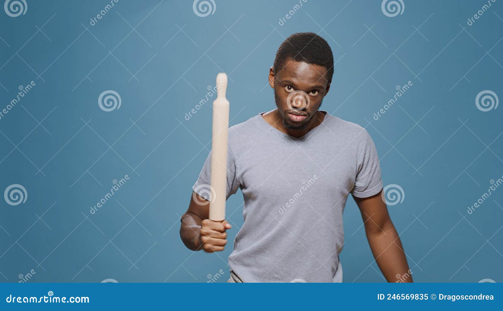aggressive upset rebel raising paddle at camera to fight