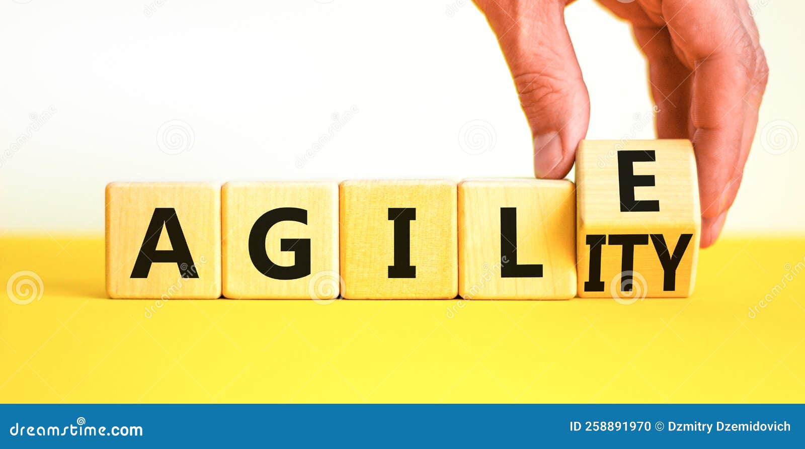 agile and agility . concept words agile and agility on wooden cubes. beautiful yellow table white background. businessman