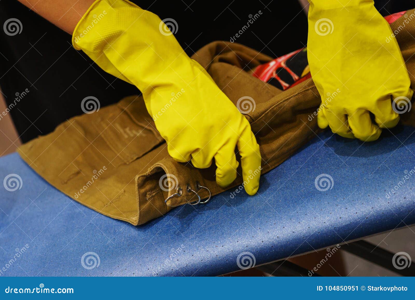 Aging Process of a Denim Jacket, the Master in Rubber Gloves Treated the Jacket with a Bleach