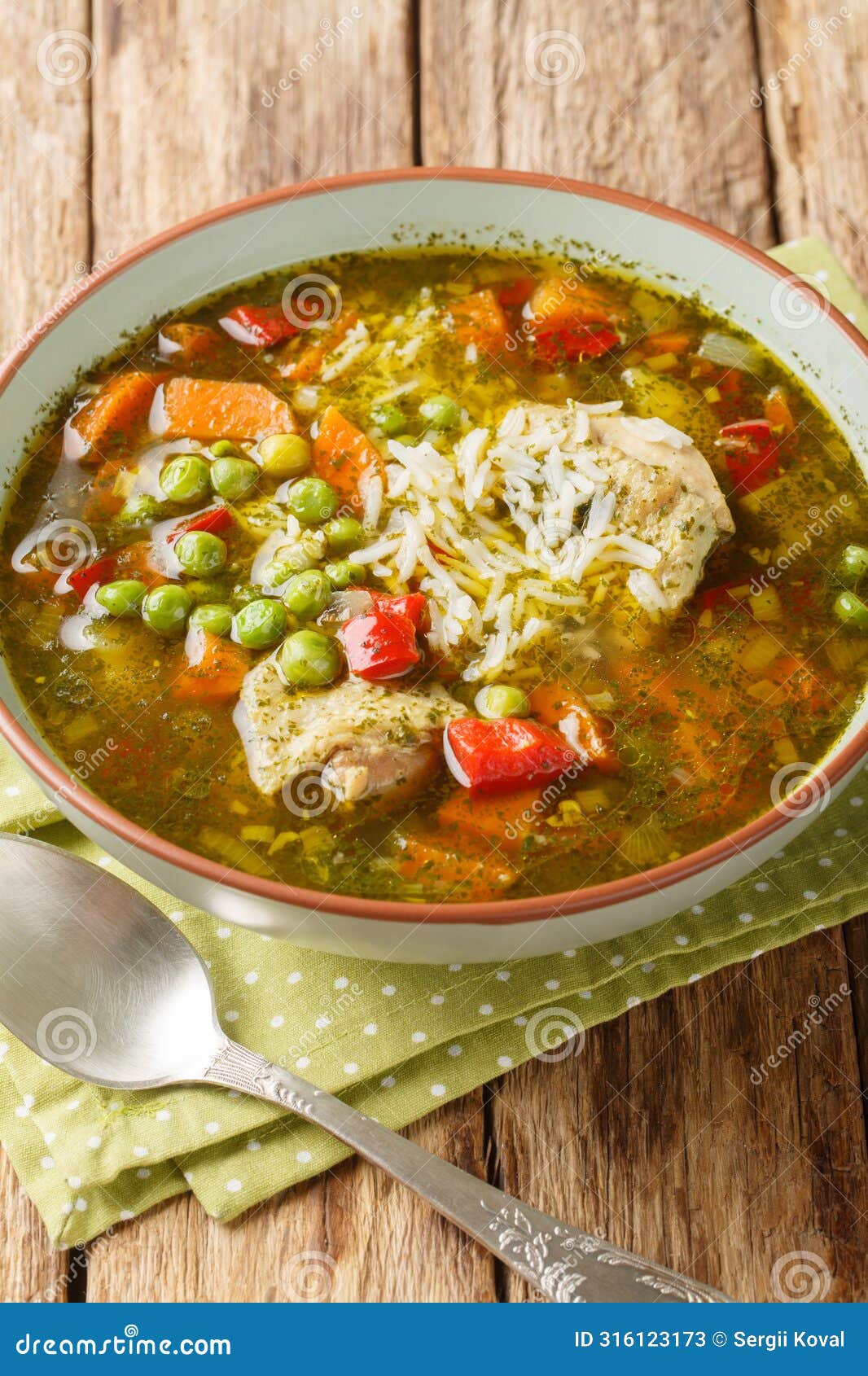 aguadito de pollo chicken and cilantro soup closeup on the bowl. vertical